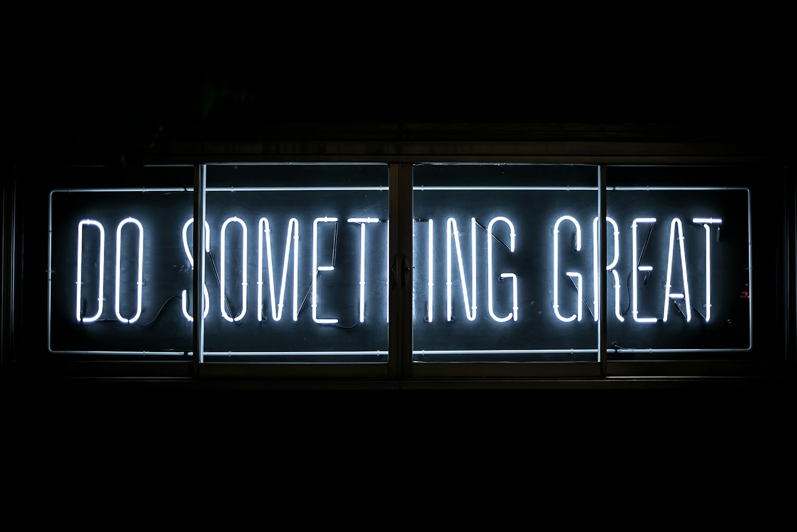 A signage in a black background saying "Do Something Great"