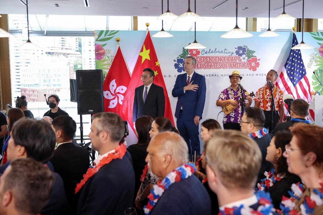 U.S. Consul General Gregory May and Hong Kong's Secretary for Commerce and Economic Development Algernon Yau Ying-wah listen to the U.S. National Anthem sung by Daniel Ho at a reception hosted by the U.S. Consulate General Hong Kong and Macau to celebrate the upcoming July 4th Independence Day anniversary, in Hong Kong, China, June 26, 2025. REUTERS/Tyrone Siu