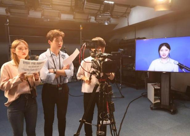 A group of people standing in front of a camera

AI-generated content may be incorrect.