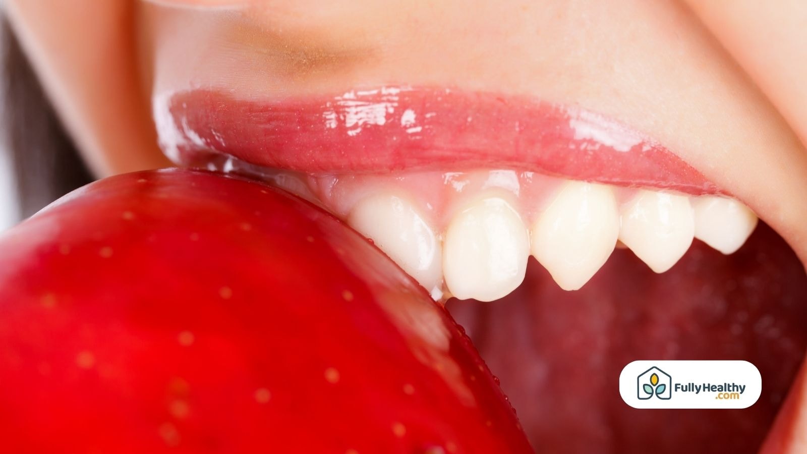 Close-up of healthy teeth and apple being bitten for oral health
