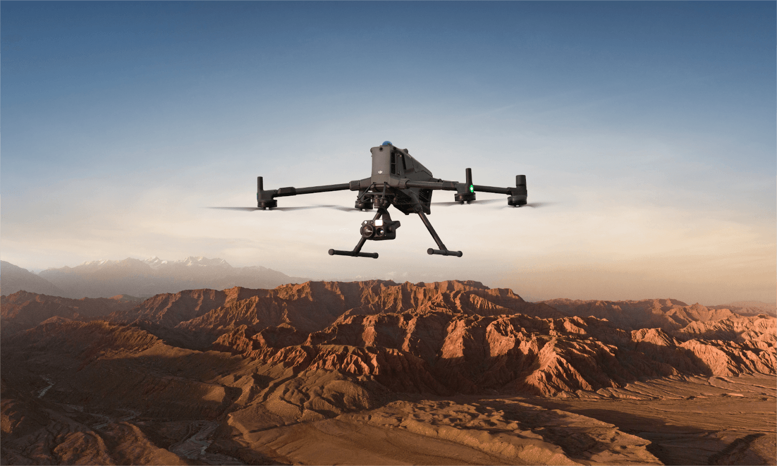 Front view of the DJI Matrice 400 drone in flight over industrial terrain, showcasing its advanced sensor array and payload capacity – symbolizing the next generation of enterprise drone technology.