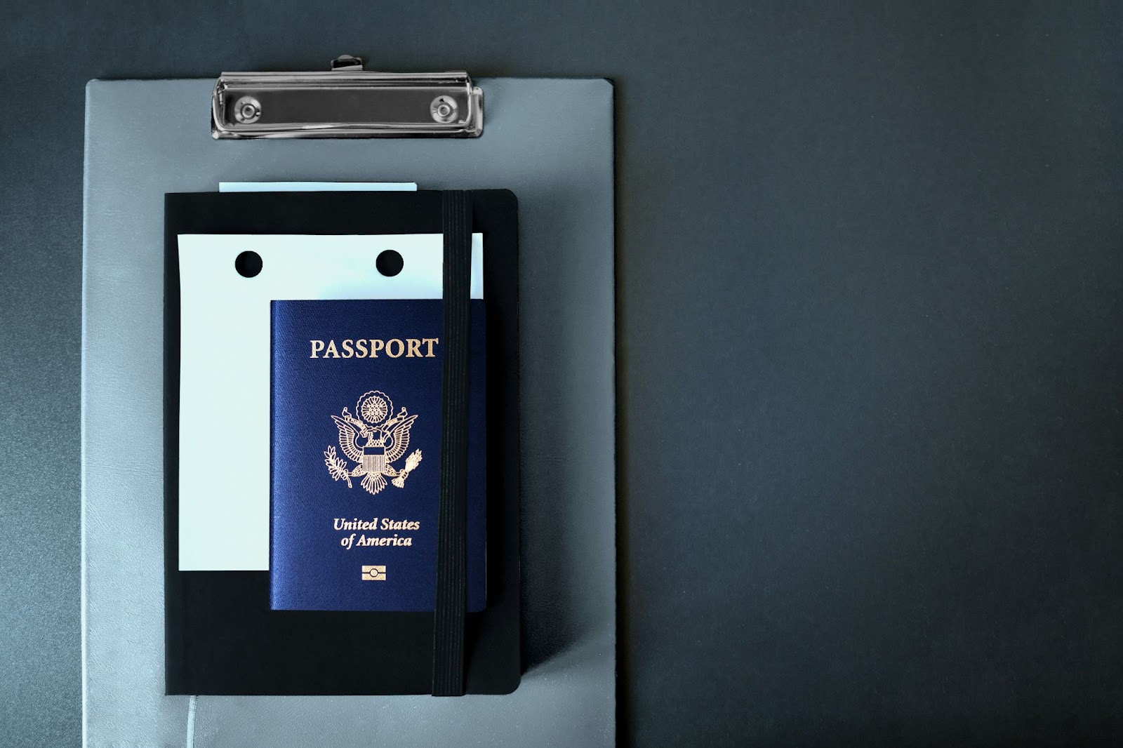 A U.S. passport resting inside a sleek blue‑and‑black presentation box, ready for international travel.