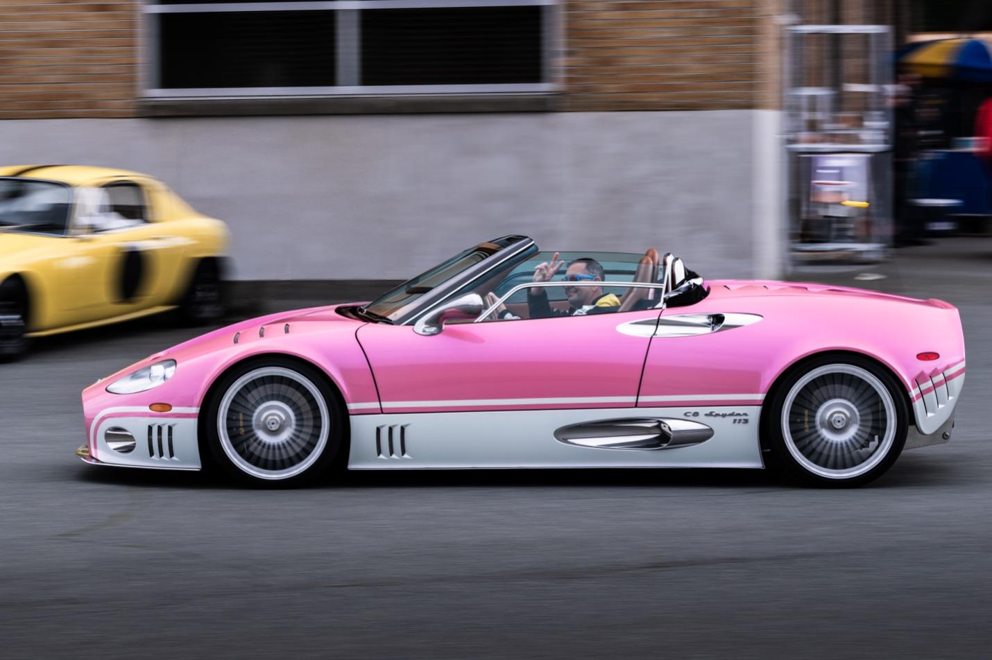 A pink and white convertible car

AI-generated content may be incorrect.