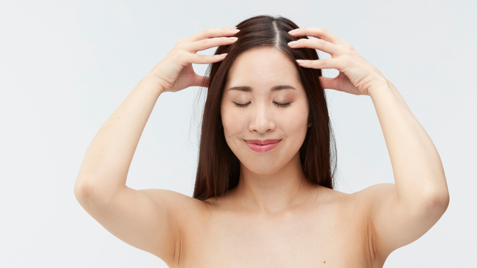 Woman using fingers to massage her scalp