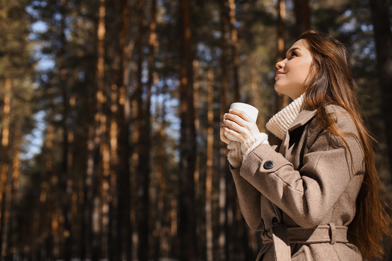 A woman wearing a wool coat with a woolen turtleneck sweater