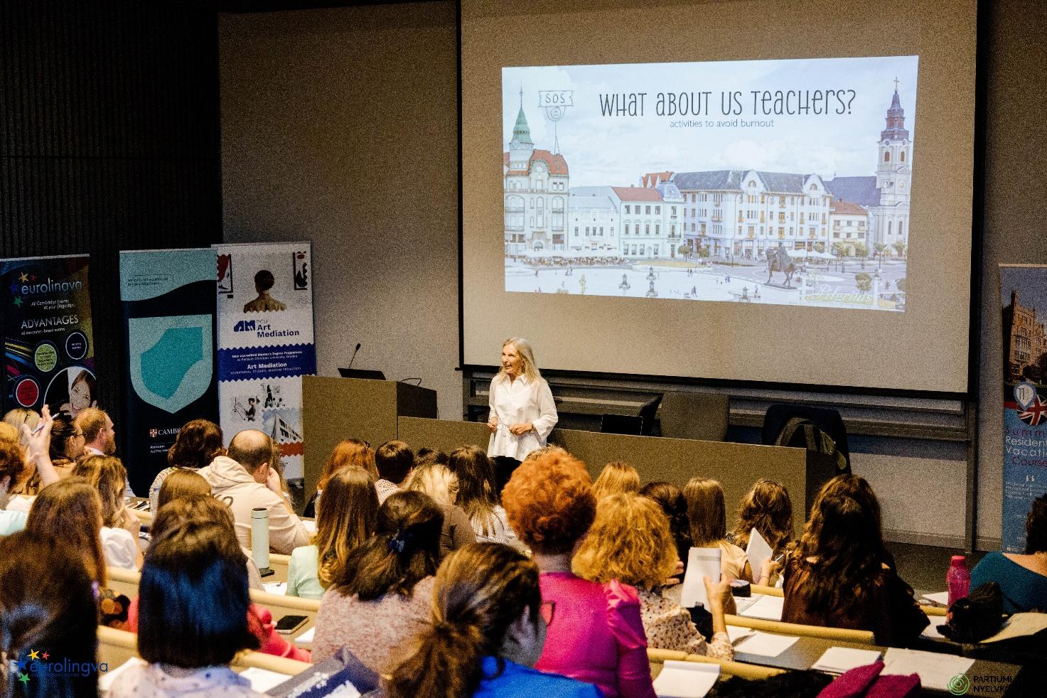 A person standing in front of a large group of peopleDescription automatically generated