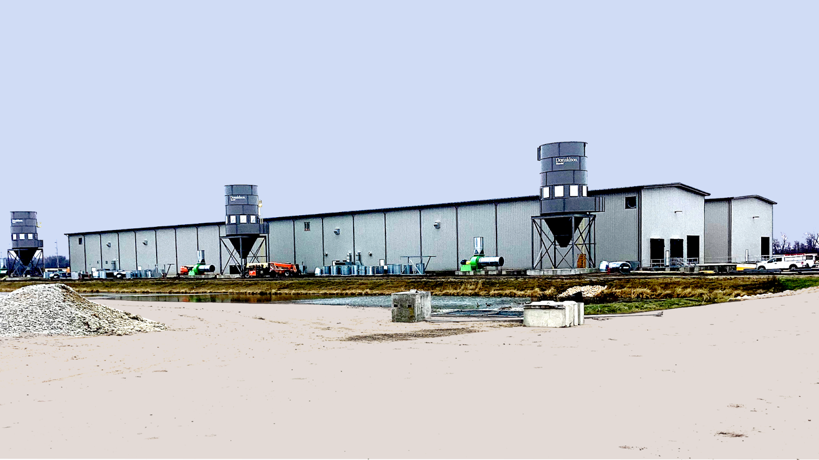 REGEN Fiber steel building with multiple units and industrial equipment outside on a clear day