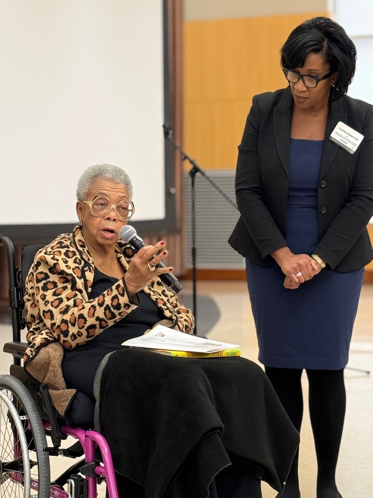 Health Equity Visionary Award honoree Shirley Nathan Pulliam (left) addresses the audience alongside Camille Blake Fall, Directo