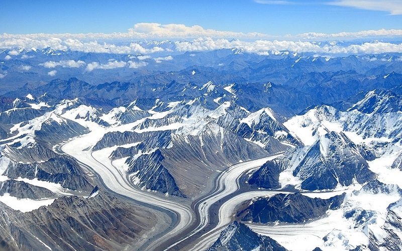 Stunning view of Ladakh, Jammu & Kashmir, featuring barren mountains, Pangong Lake, and ancient monasteries under a clear blue sky.