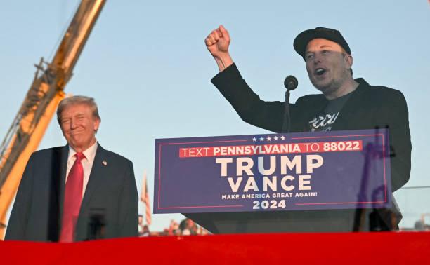 Tesla CEO Elon Musk speaks on stage as he joins former US President and Republican presidential candidate Donald Trump during a campaign rally at...