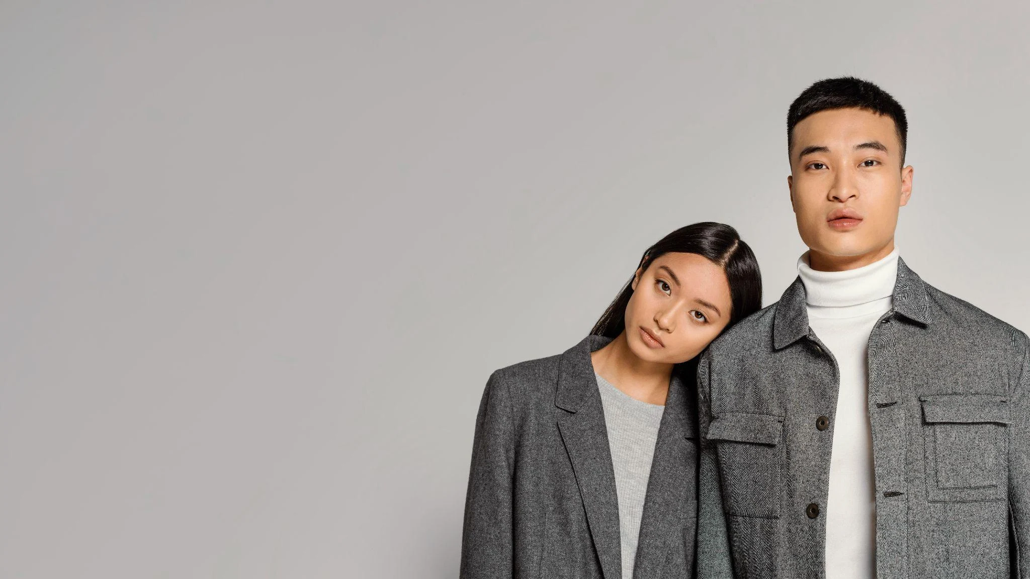 young japanese man and woman in crisp minimalist outfits