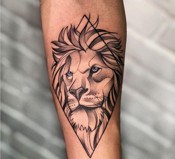 Geometric lion tattoo on forearm with detailed mane and piercing eyes, blending tribal and contemporary art styles.