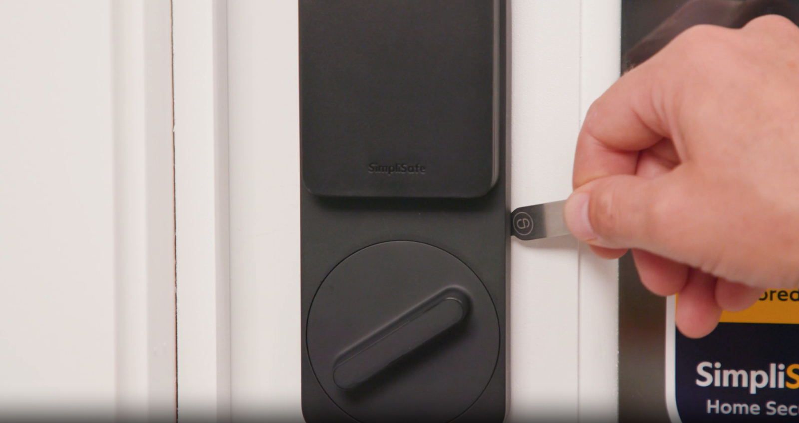 The Smart Lock release tool being used to expand the wing latches on the Smart Lock Series 2