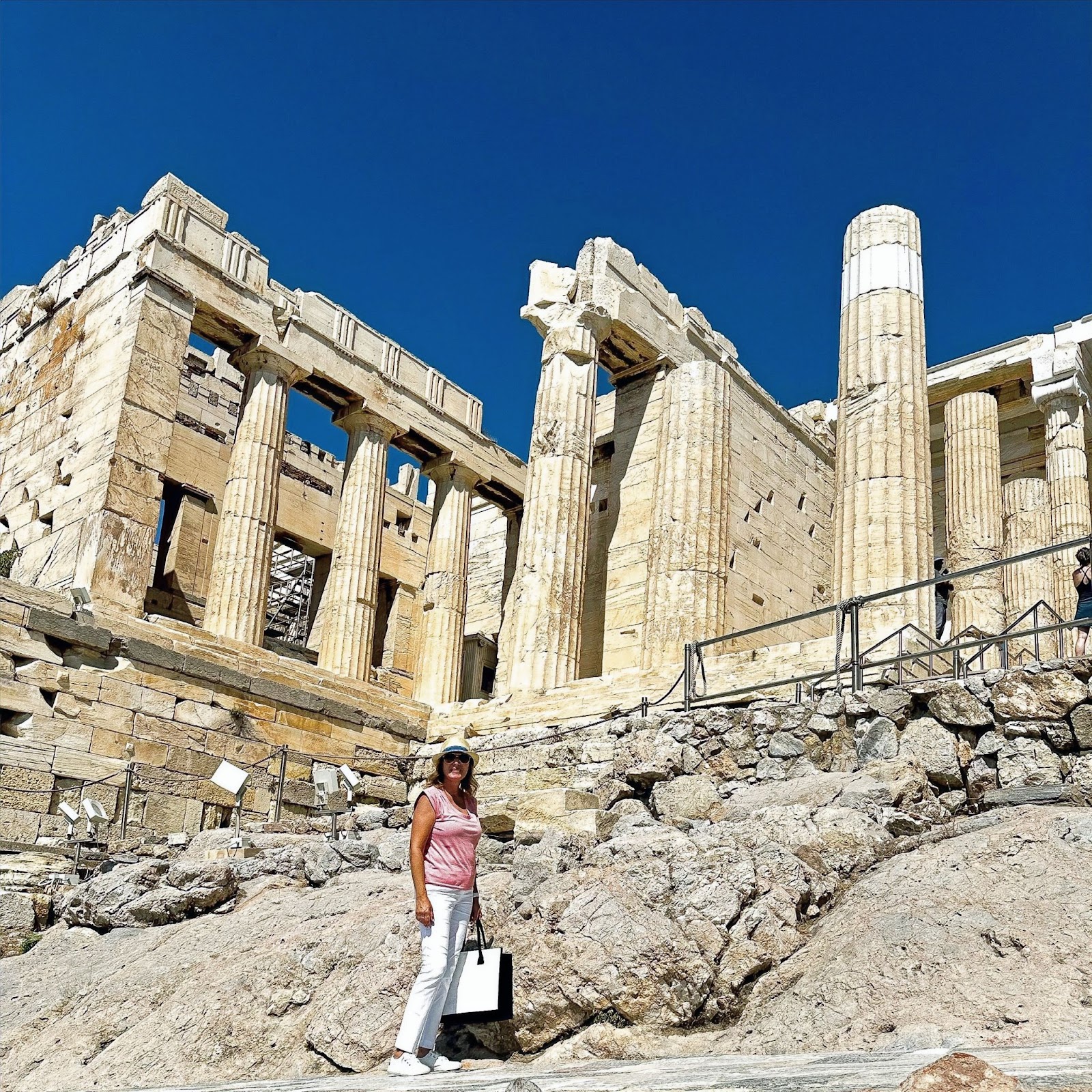 The Acropolis of Athens, woman standing in front of the ruins