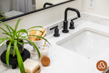 how to select the perfect countertops for your bathroom remodel quartz countertop with matte black faucet and veined backsplash custom built michigan