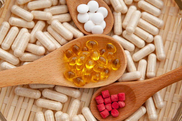 A neatly arranged plate containing various colorful supplements, symbolizing health and wellness.