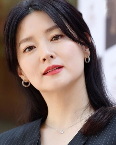 This contains an image of Lee Young Ae