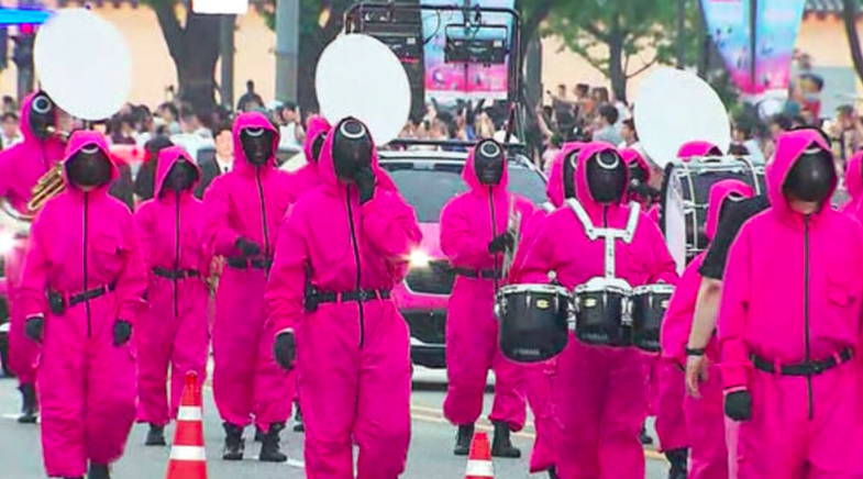 This contains an image of Squid Game Seoul parade