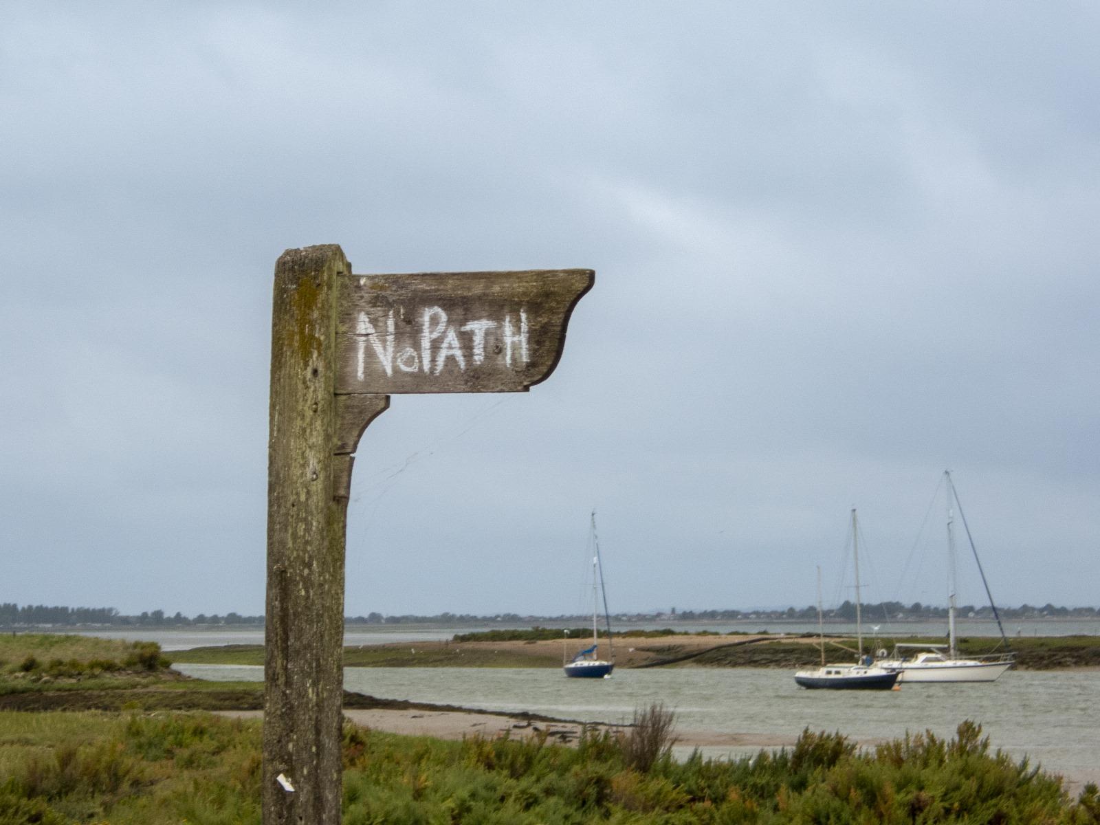 A wooden sign with white text

Description automatically generated