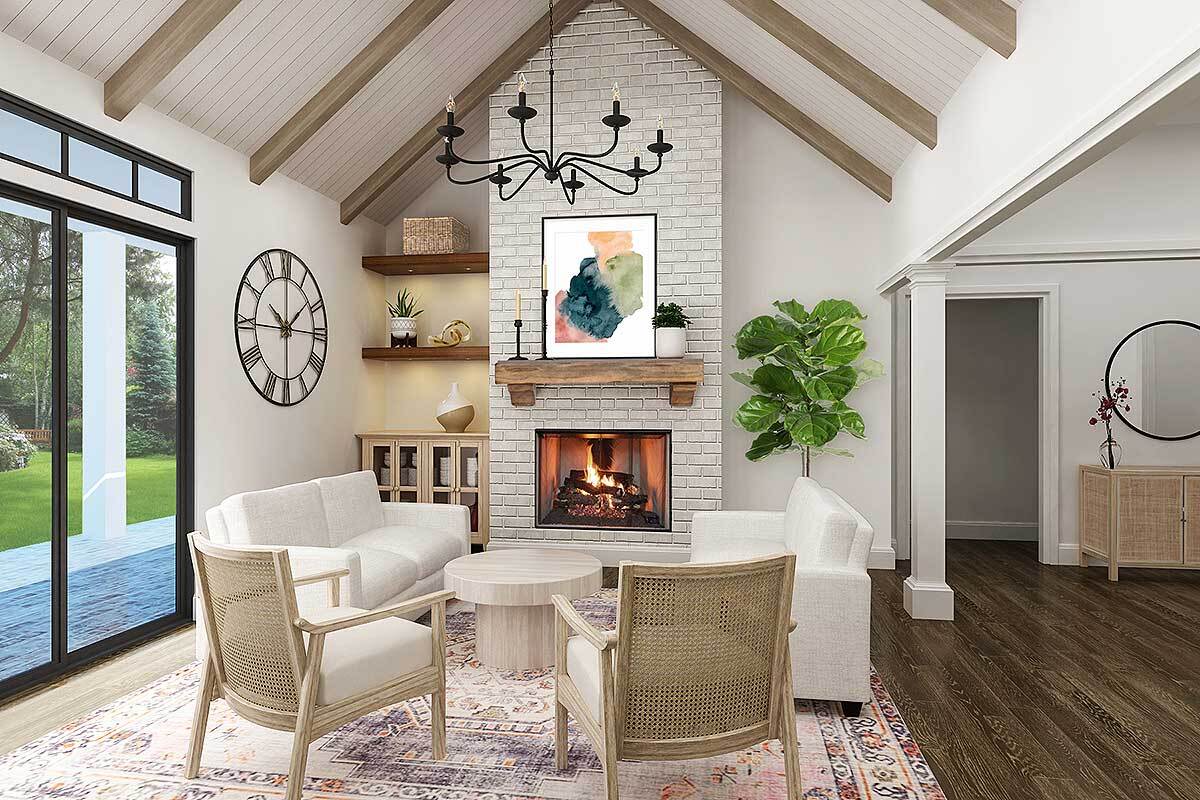 Living room with white seats, a brick fireplace, and a cathedral ceiling lined with exposed wood beams.