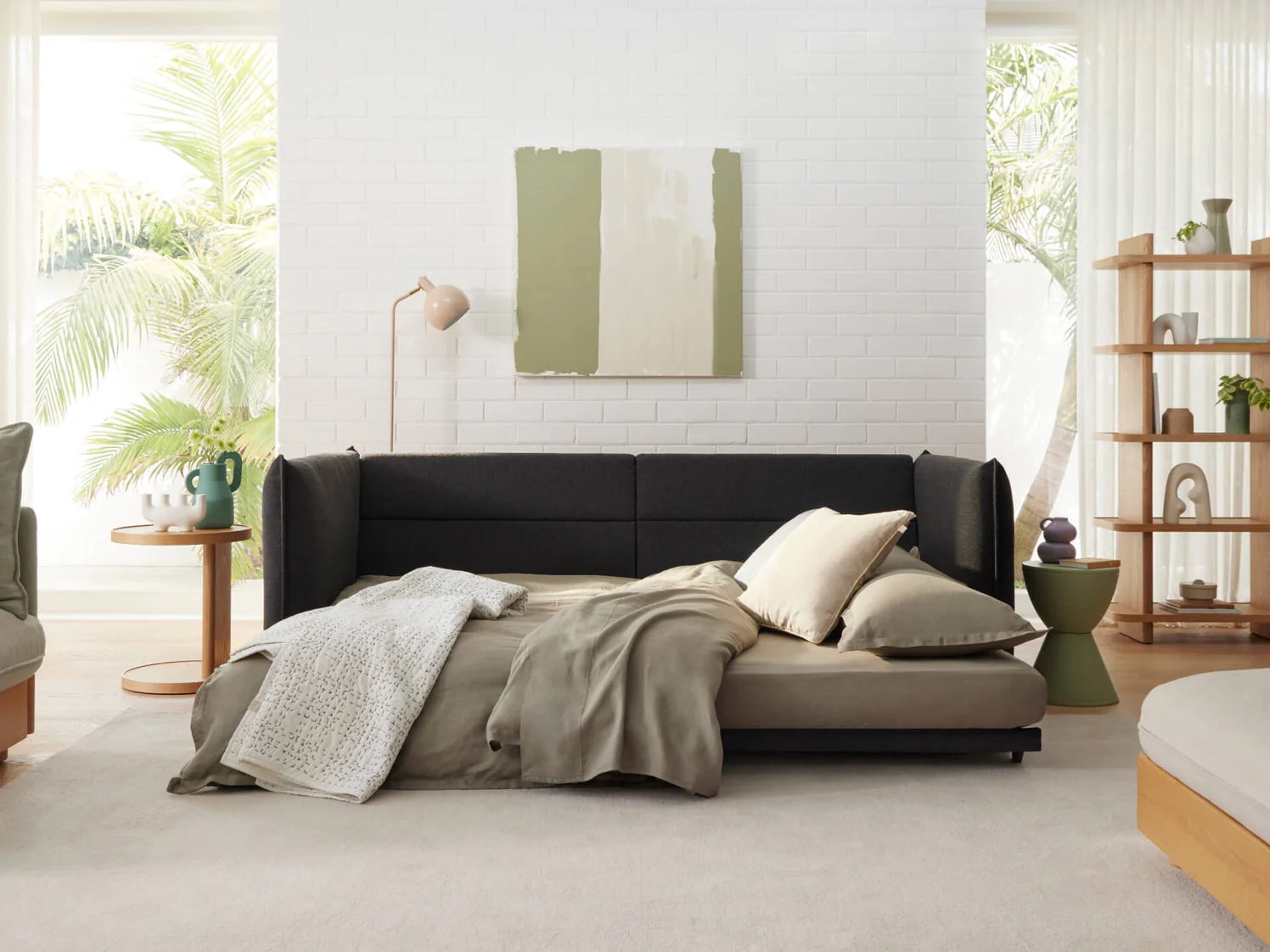 sleeper sofa with a clean setup and colorful pillows