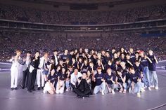 This contain SMTOWN concert  standing on top of a stage in front of an audience