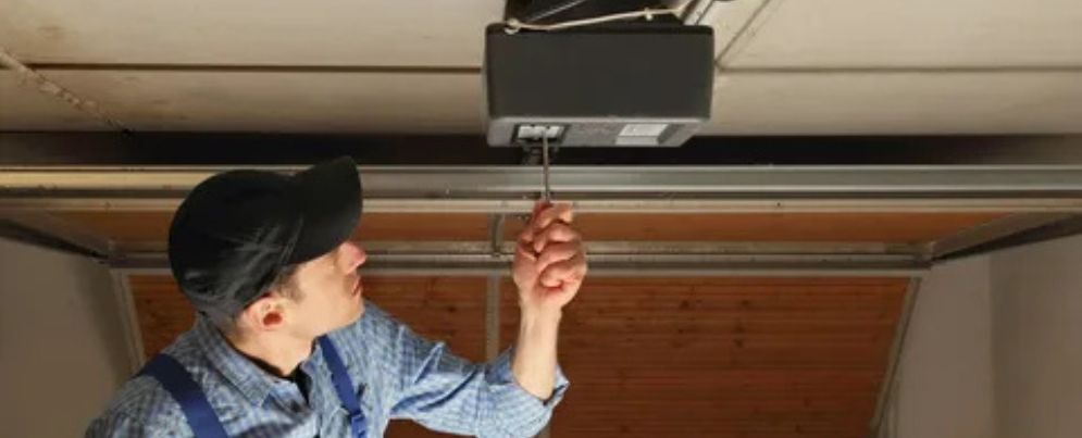 garage door repair man inspecting garage door