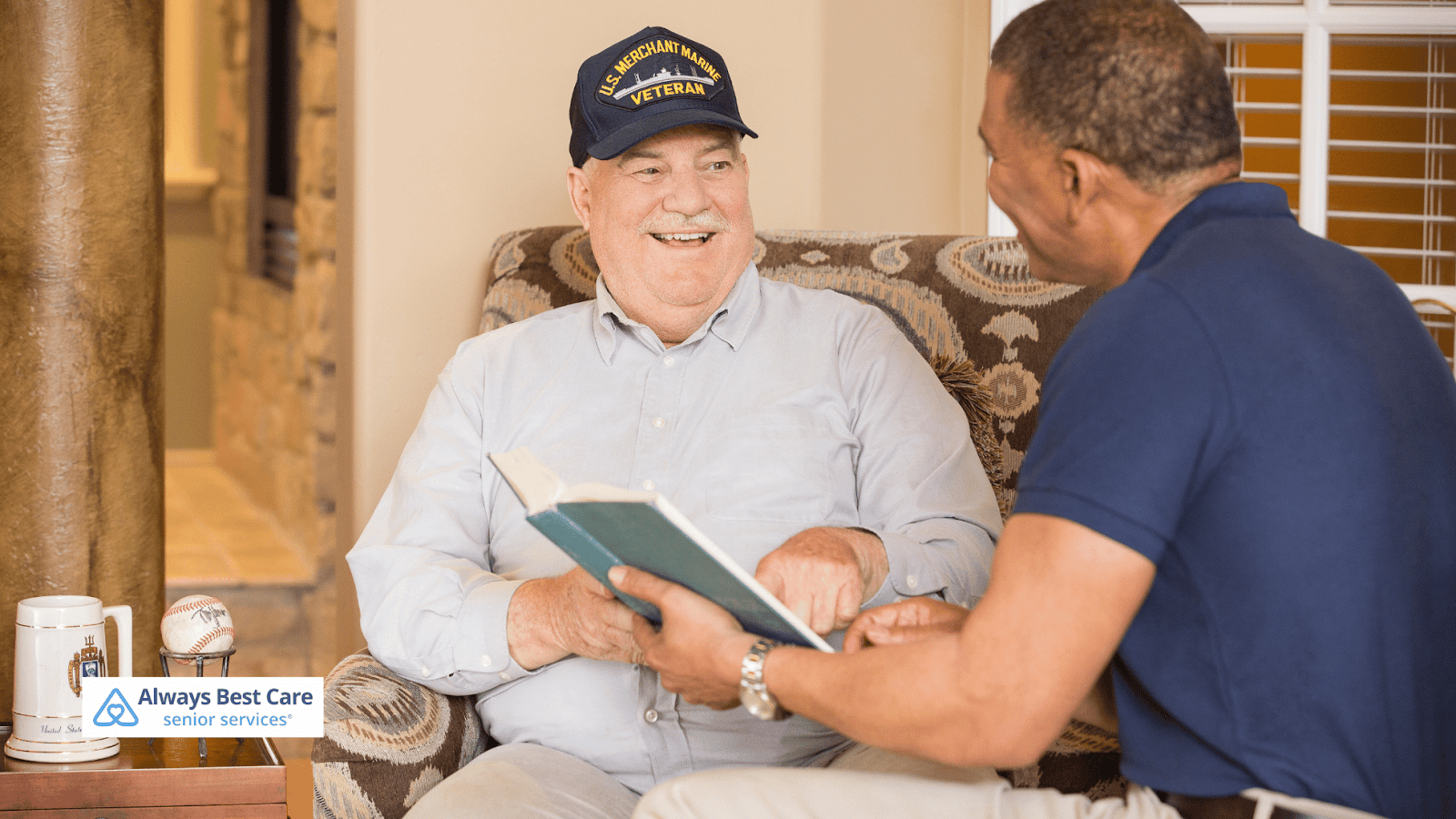 This image depicts a senior man and a caregiver talking