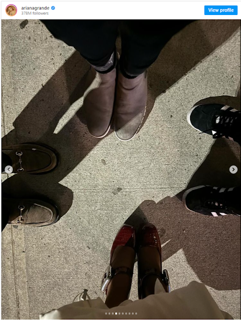 A group of people's feet and shoes

Description automatically generated