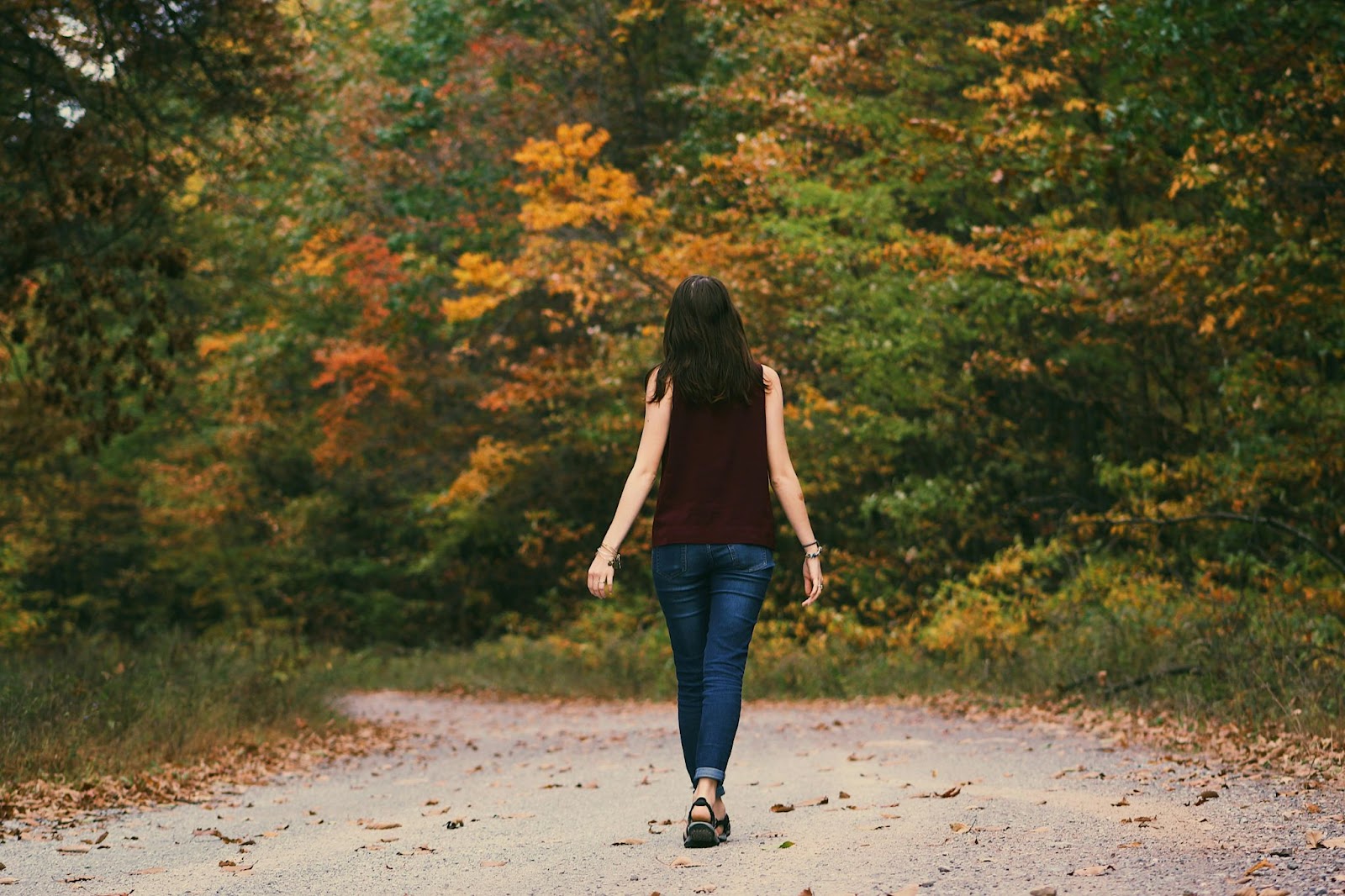 A woman walking on a path in the woods