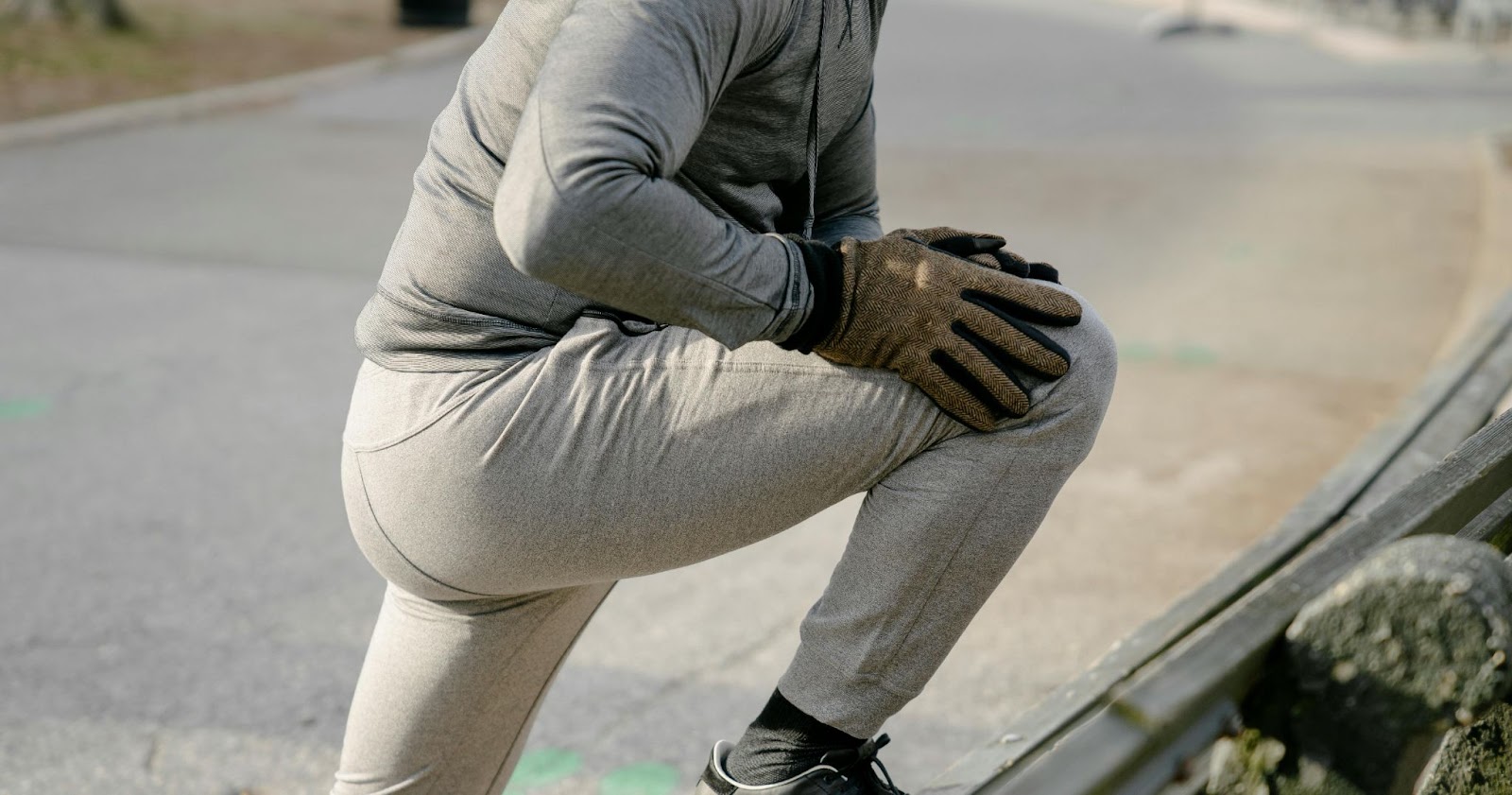 A man stretching his leg after a jog