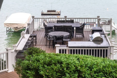 top deck designs for enjoying northern michigan lakeside decking area with dining table and outdoor kitchen custom built boyne city