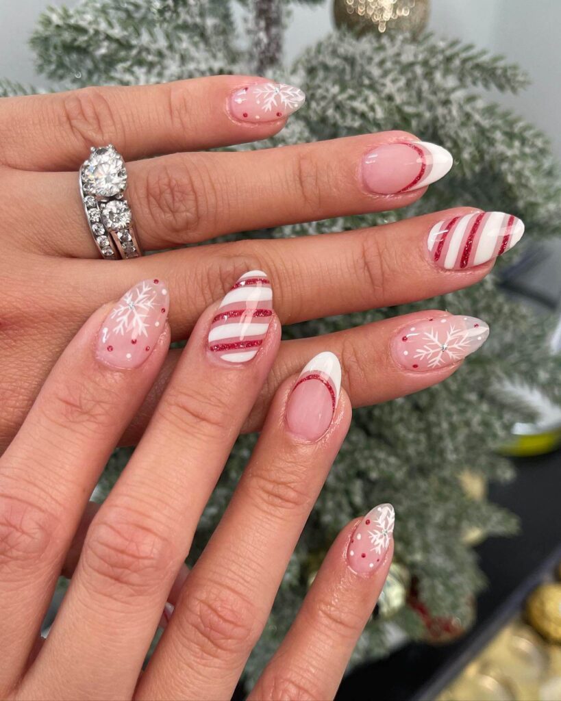 Festive Christmas nail designs featuring red and green nails with glitter accents, snowflakes, and holiday-themed nail art.