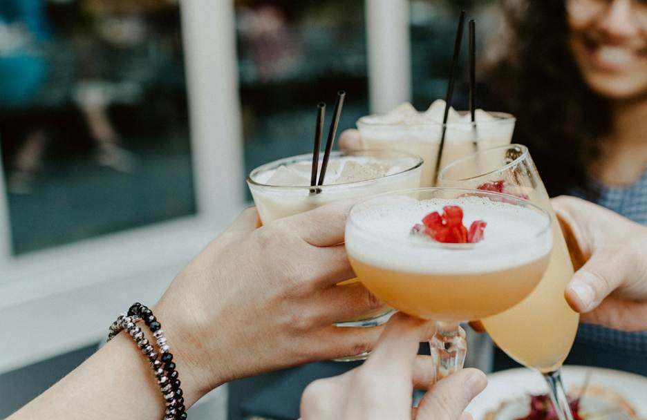A group of hands holding glasses with drinks

AI-generated content may be incorrect.