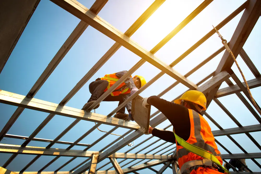 A group of men working on a metal structure
Description automatically generated