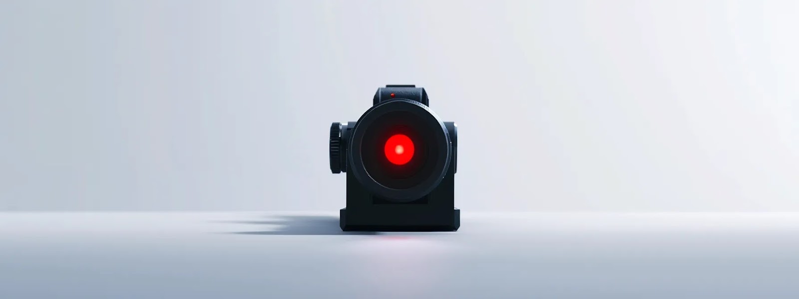 a sleek, modern red dot sight displayed on a clean, white background.