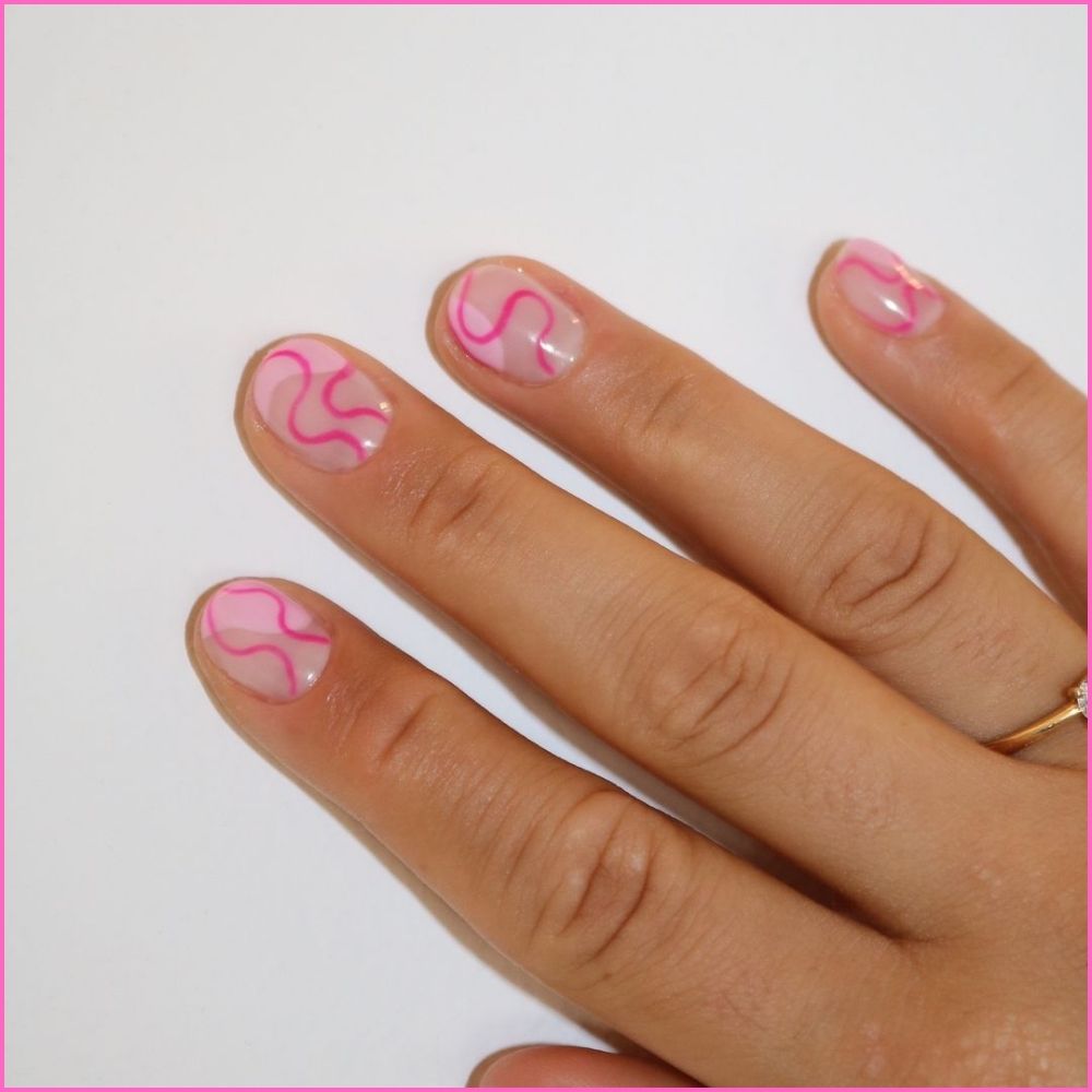 Close up of nails with simple pink nail designs having Pink Swirl Nails