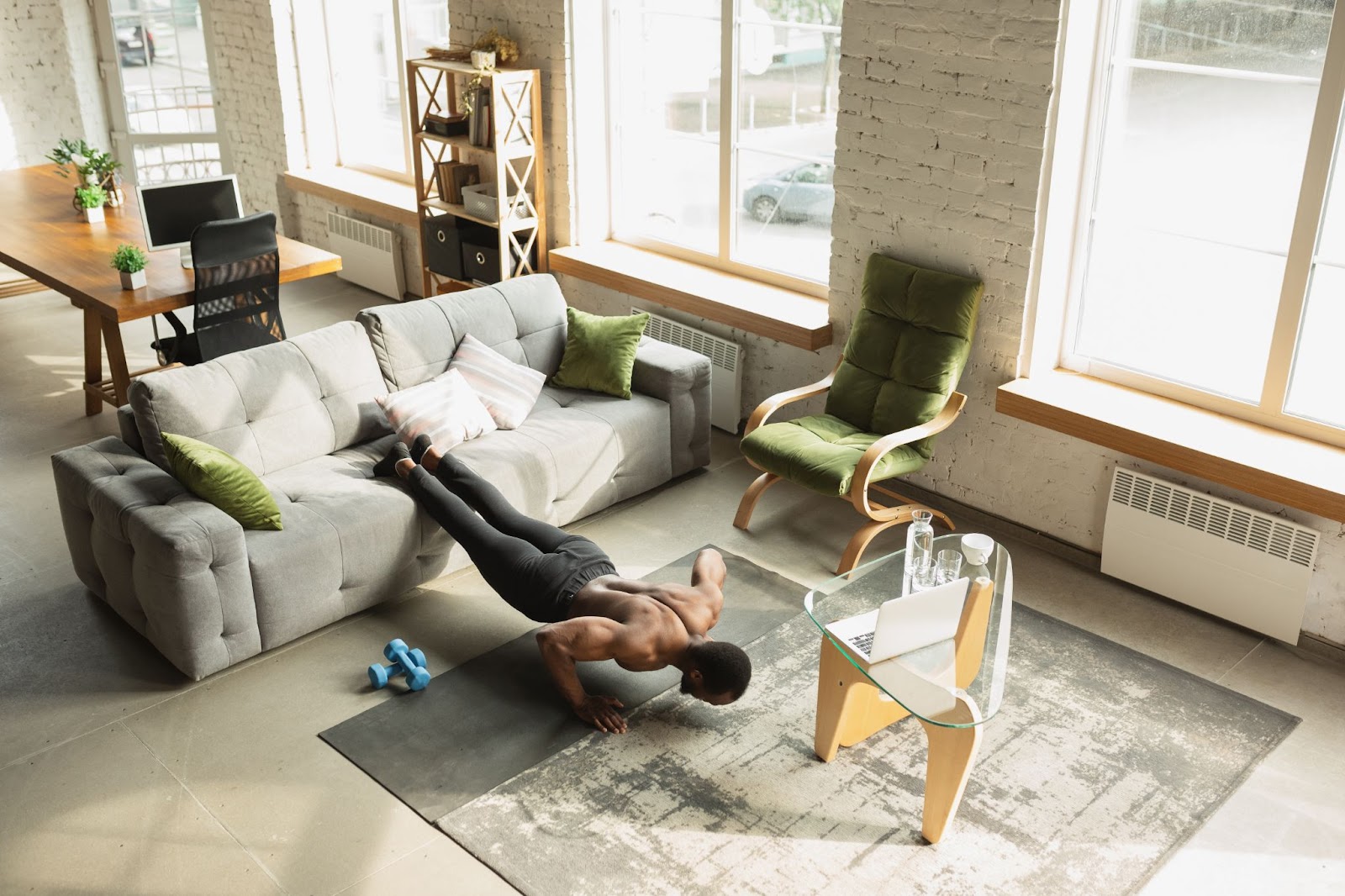 Young African American man training home doing exercise aerobics