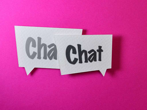 two speech bubbles on a pink background