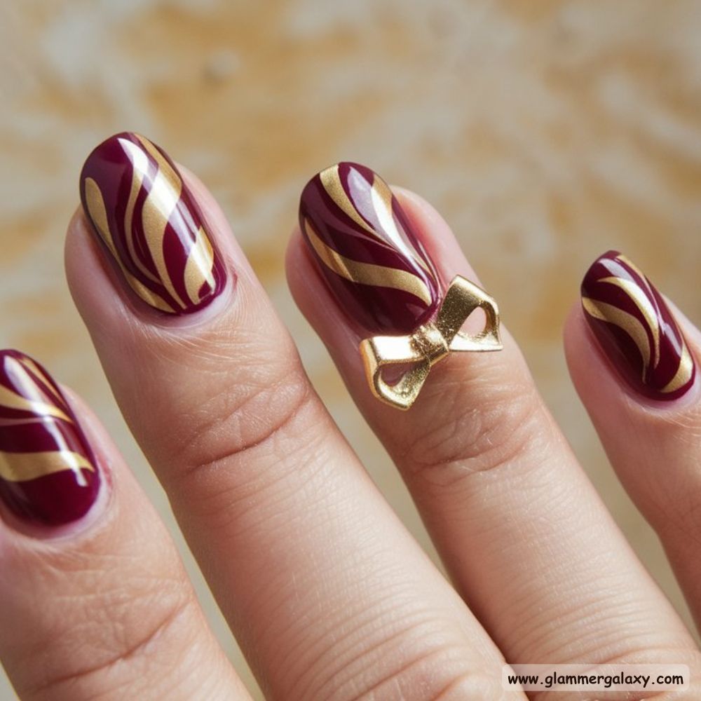 Burgundy fall Nails with Artistic Swirl Patterns