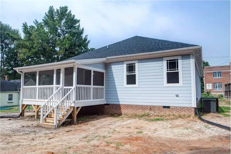 Rear exterior view with an elevated screened porch framed with white trims.