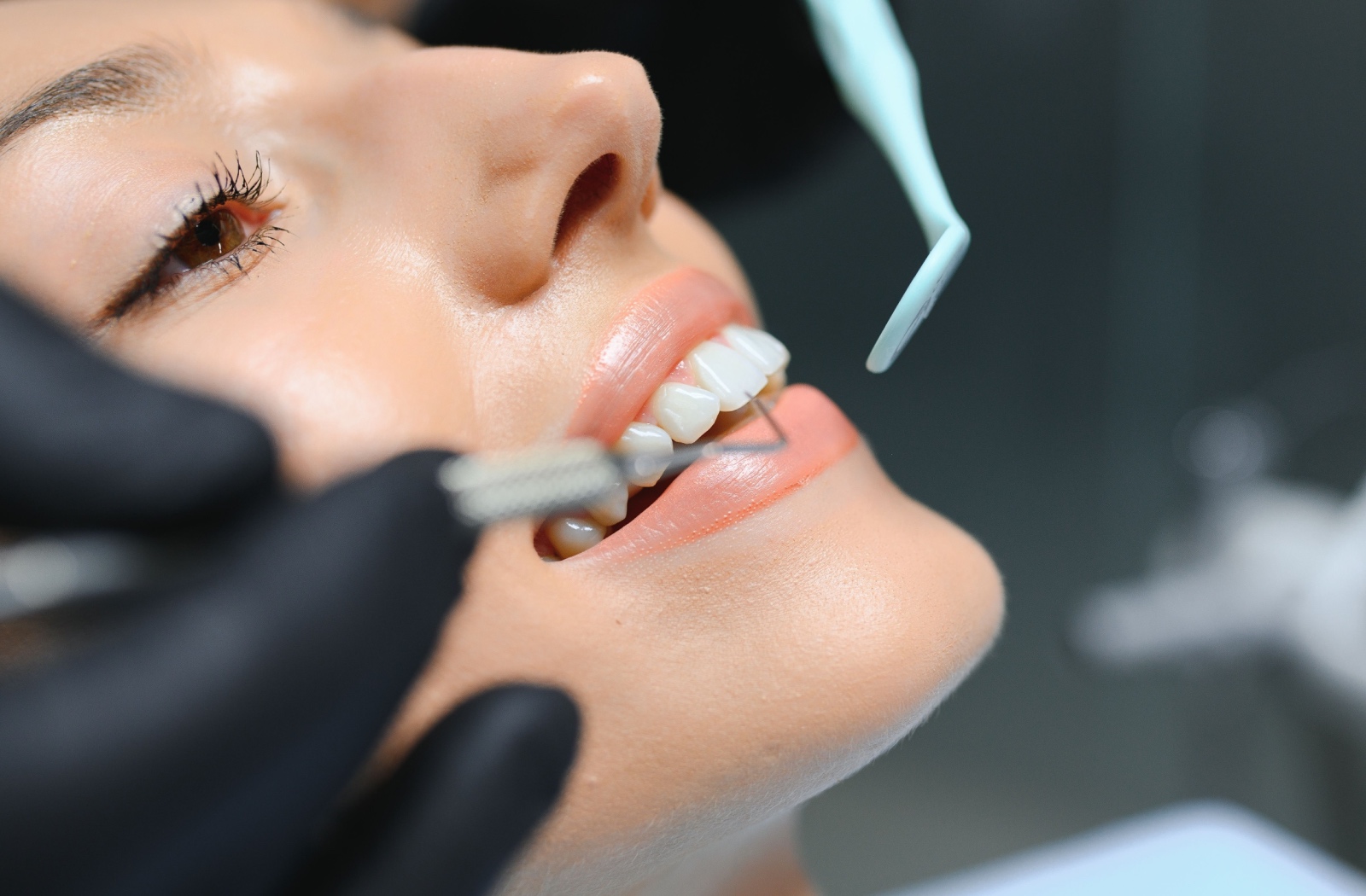 A patient being evaluated by a dentist during a routine screening for oral health and disease.