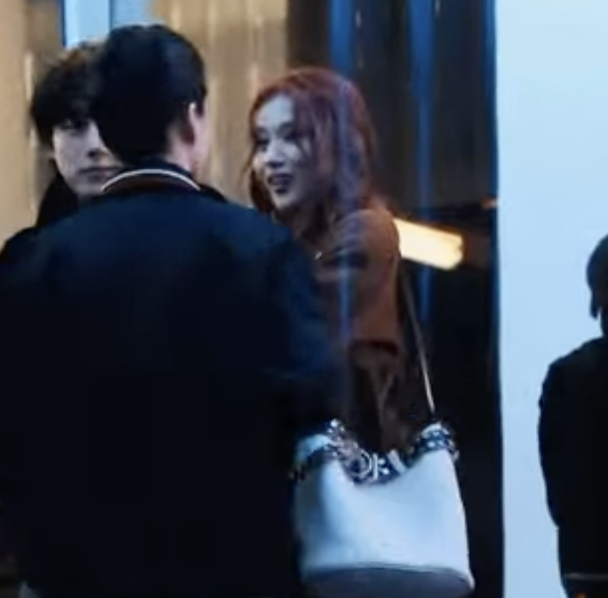 A picture of TWICE Sana and a man in PRADA Men's Fashion Week Fall/Winter 2025