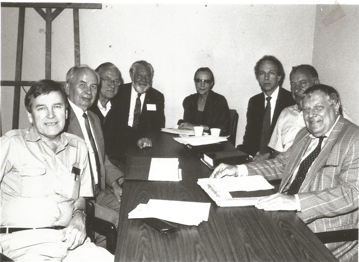 A group of people sitting around a table AI-generated content may be incorrect.