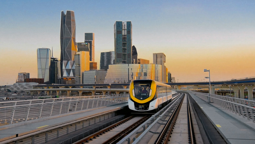 Riyadh Metro on the tracks with office buildings in the background - (Credits Railway Supply)