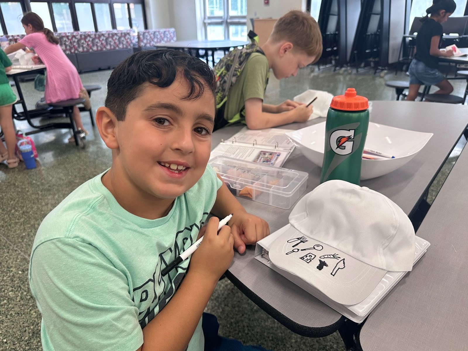 child designing hat