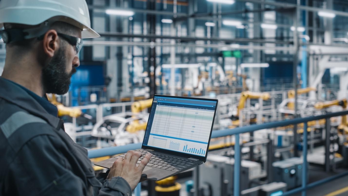 Man with laptop in factory