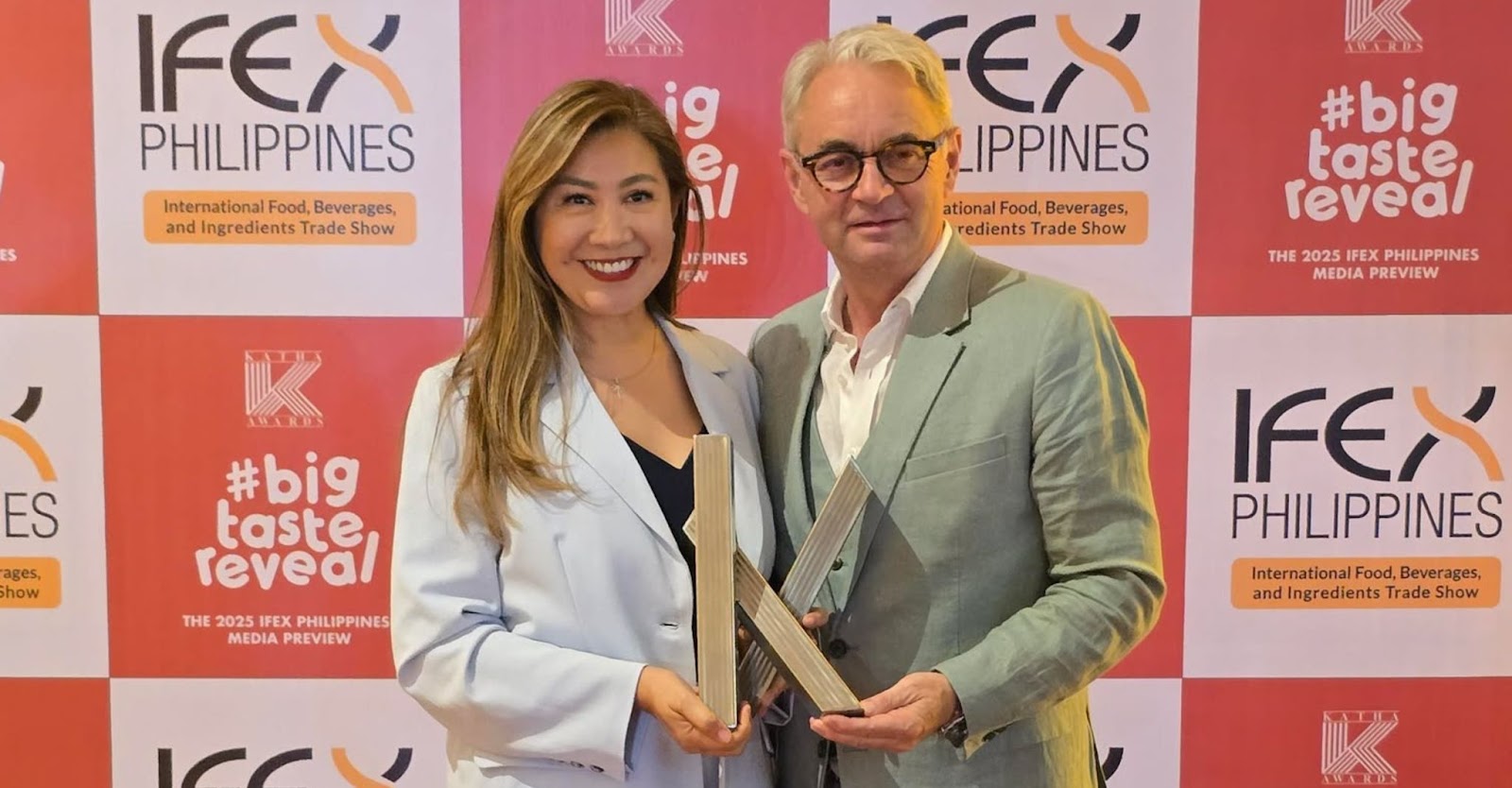 CEO Christian Moeller and COO Cecille Chang holding the KATHA Award 2025