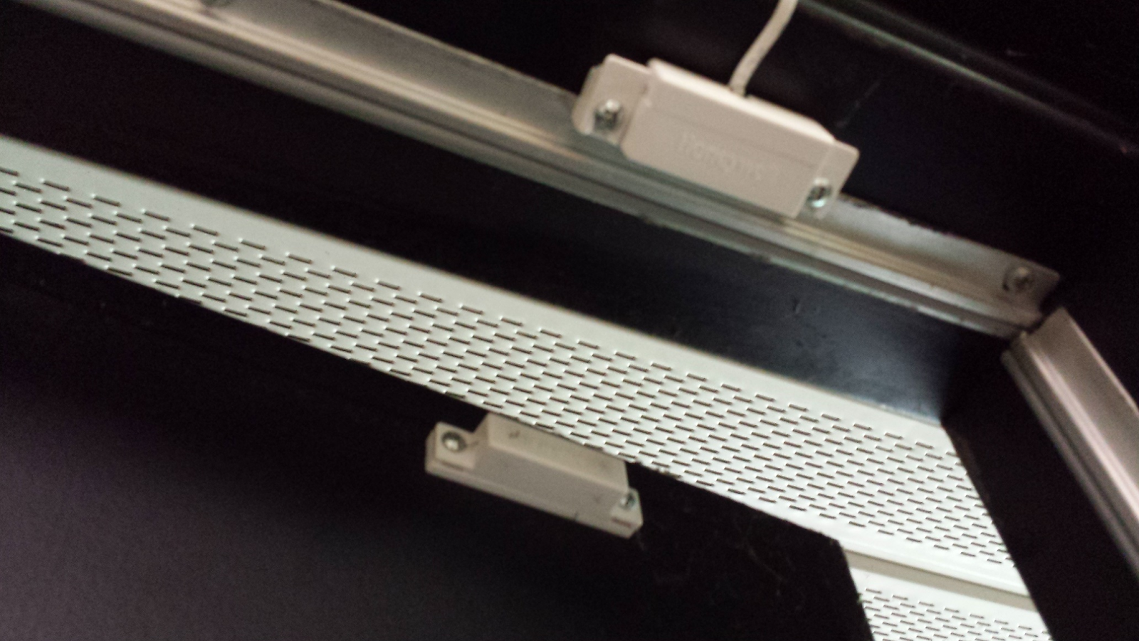 door contact sensor installed on the top of a door