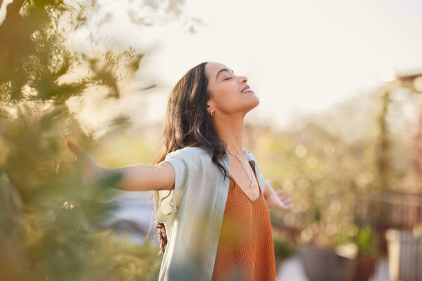 A relaxed woman smiling slightly, feeling relieved from PMS insomnia after finding effective solutions.